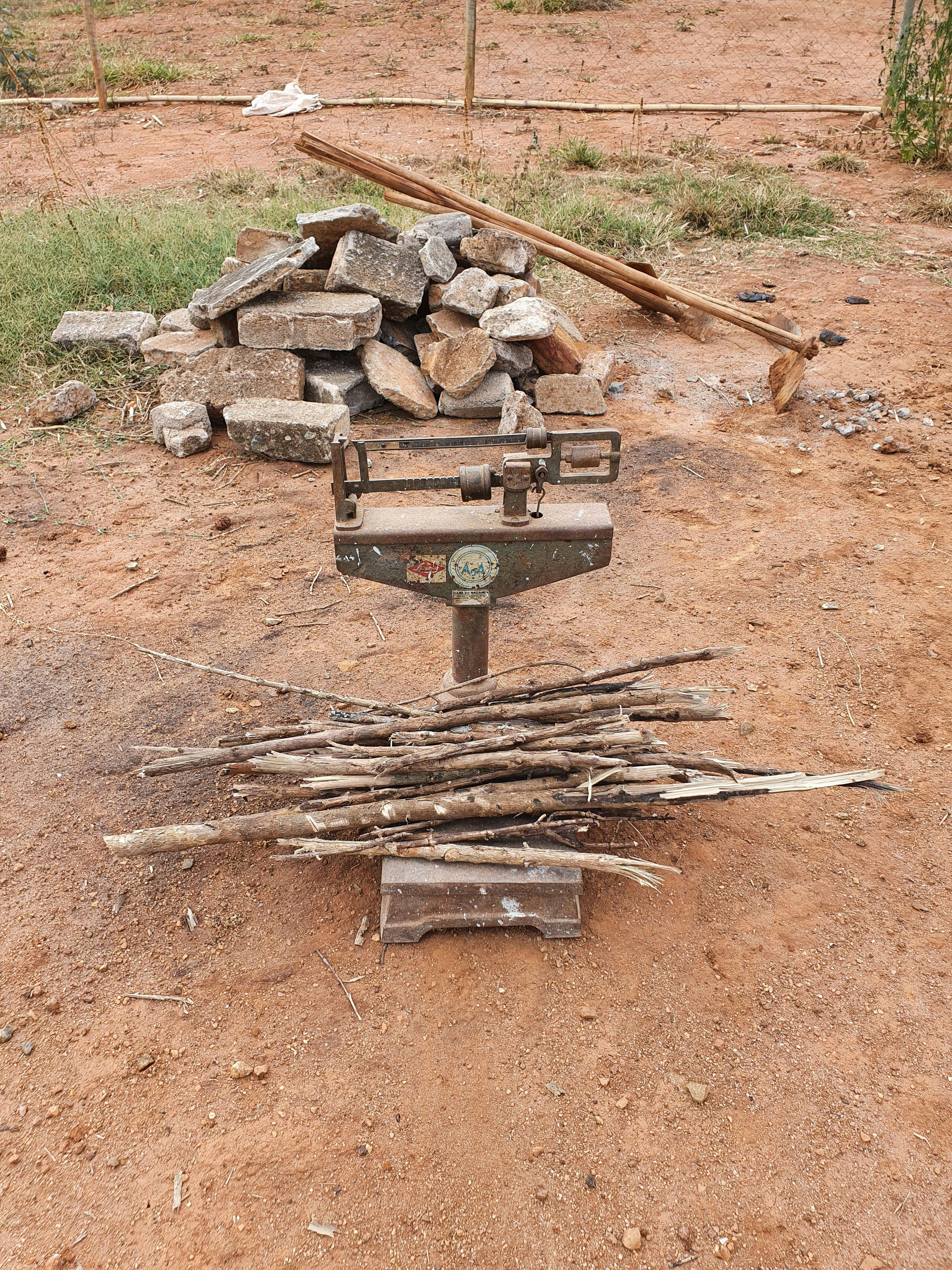 a stack of sticks is sitting next to a scale that says ' king ' on it