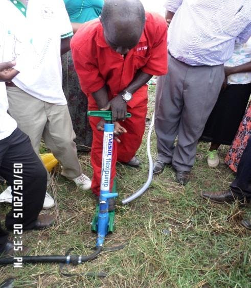 a man in a red shirt is working on a flexi pump